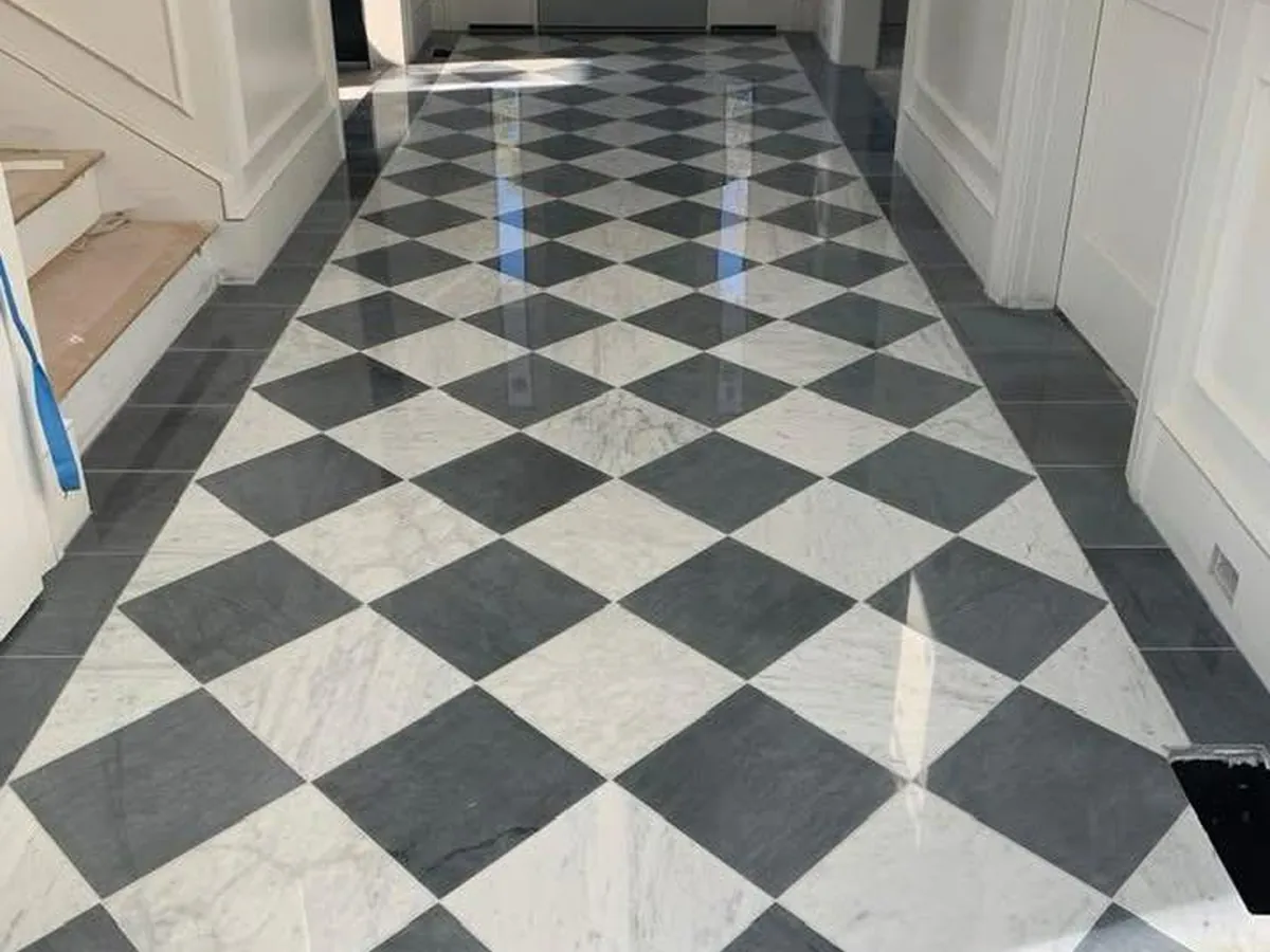 Black and white checkerboard tile floor in an entry hall