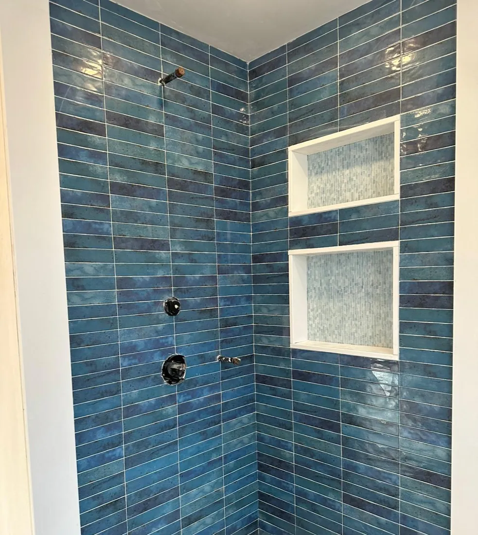 Blue glazed tile shower with a double niche