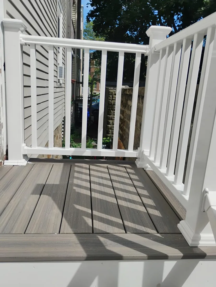 Composite porch deck with white railings