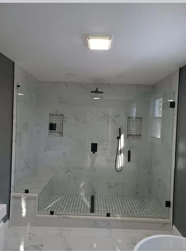 Frameless glass shower with matte black fixtures