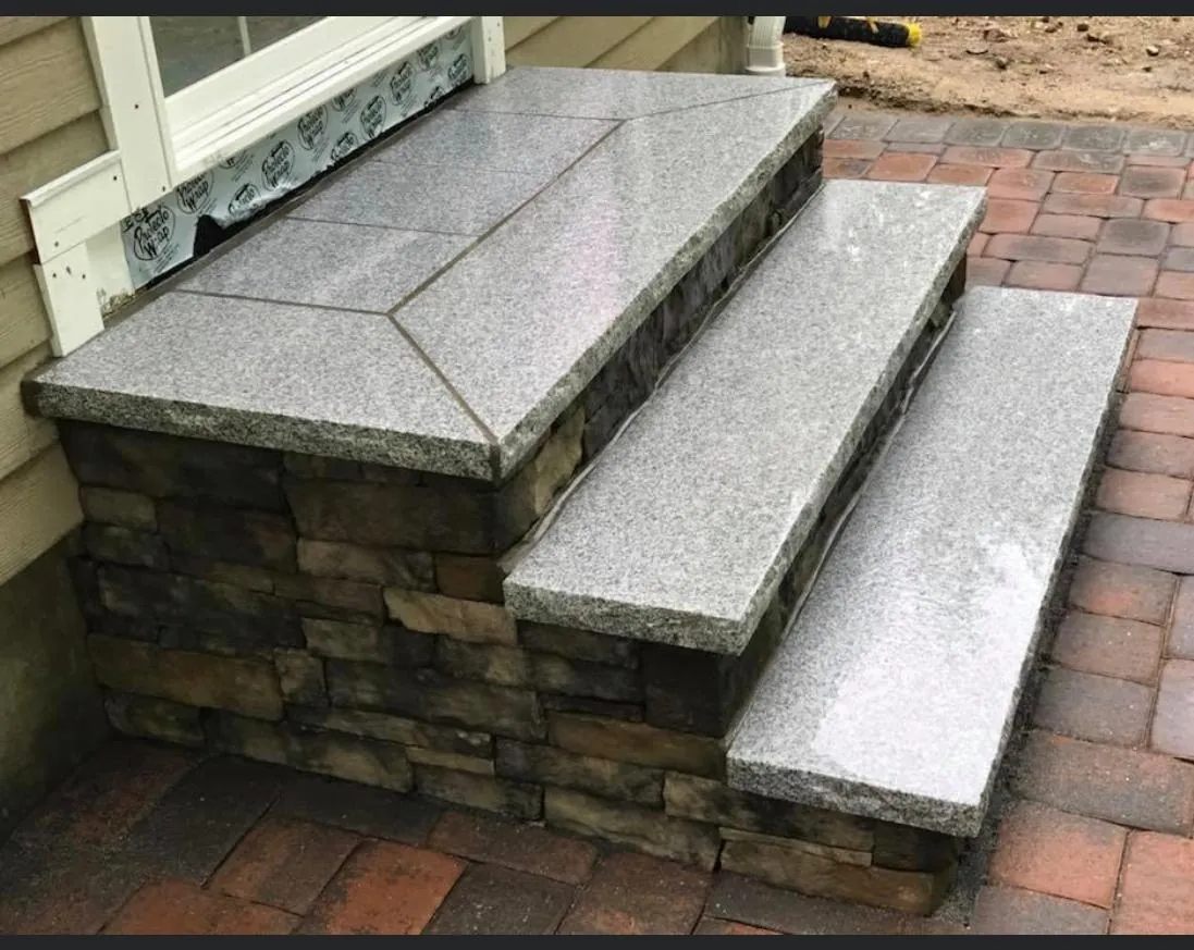 Granite steps with stone veneer risers