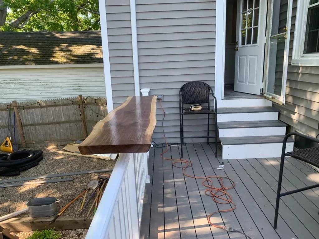 Gray composite deck with a live-edge bar top