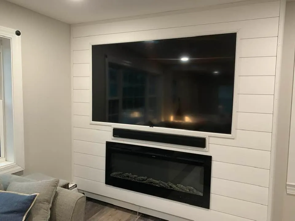Shiplap accent wall with an electric fireplace