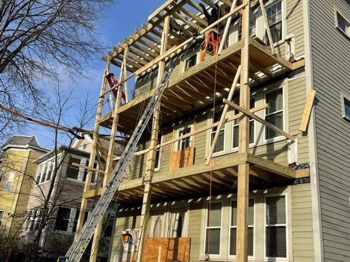 Three-story rear porch framing on a Massachusetts multifamily home