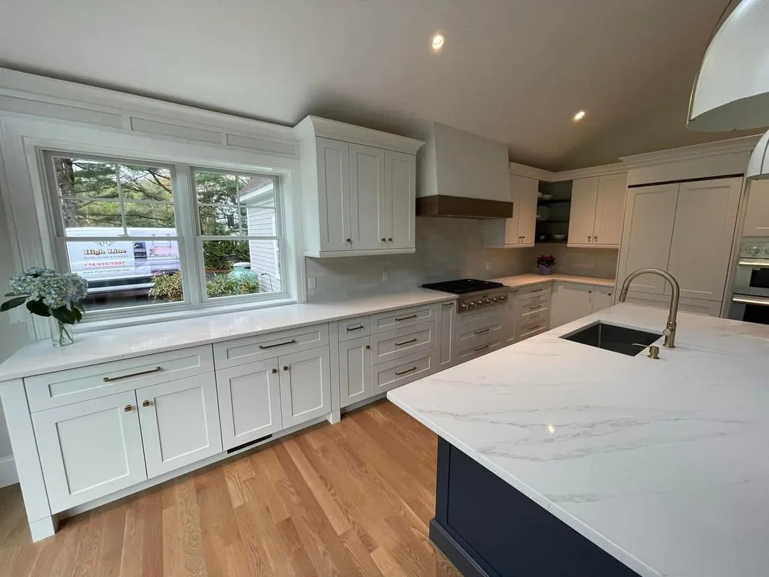 White shaker kitchen with a navy island and quartz tops
